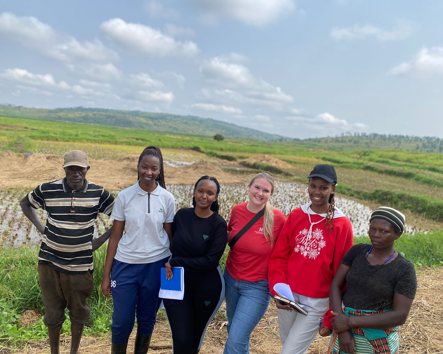 Ashton Boehm with her group of RICA students and rice farmers on the rice patties in Gashora.
Photo Credit: Ashton Boehm
 