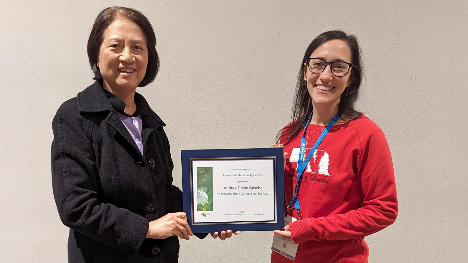 Suduan Gao, Chair of the Environmental Quality Section of the American Society of Agronomy (left), awards Andrea Basche the ASA Environmental Quality Section Inspiring Early Career Scientist Award