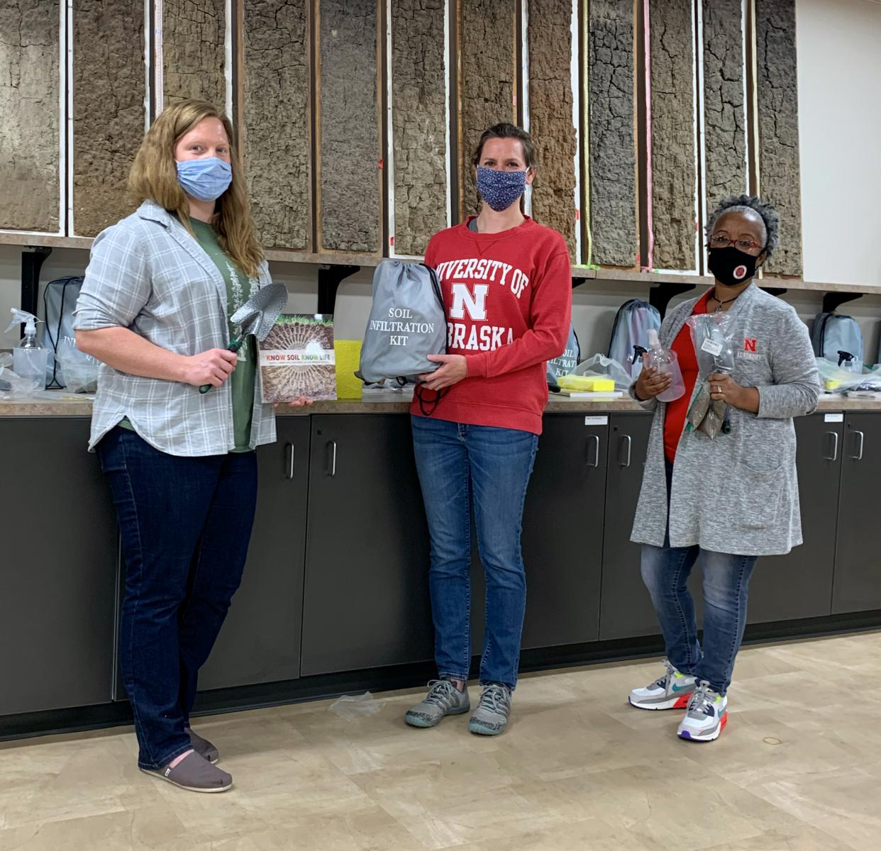 Becky Young, Meghan Sindelar and Martha Mamo prepare kits of classroom supplies for soil science activities 