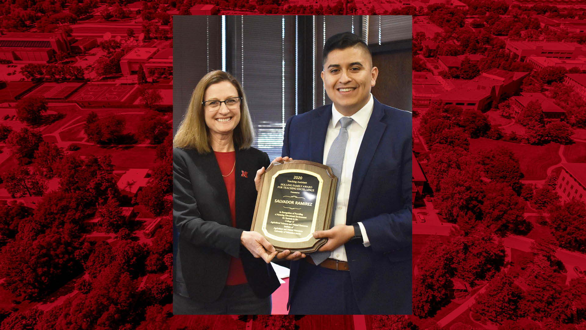 Betty Walter-Shea, CASNR interim associate dean (left), presents Salvador Ramirez with the Holling Family Teaching Assistant Teaching Excellence award March 11 at the Nebraska East Union.