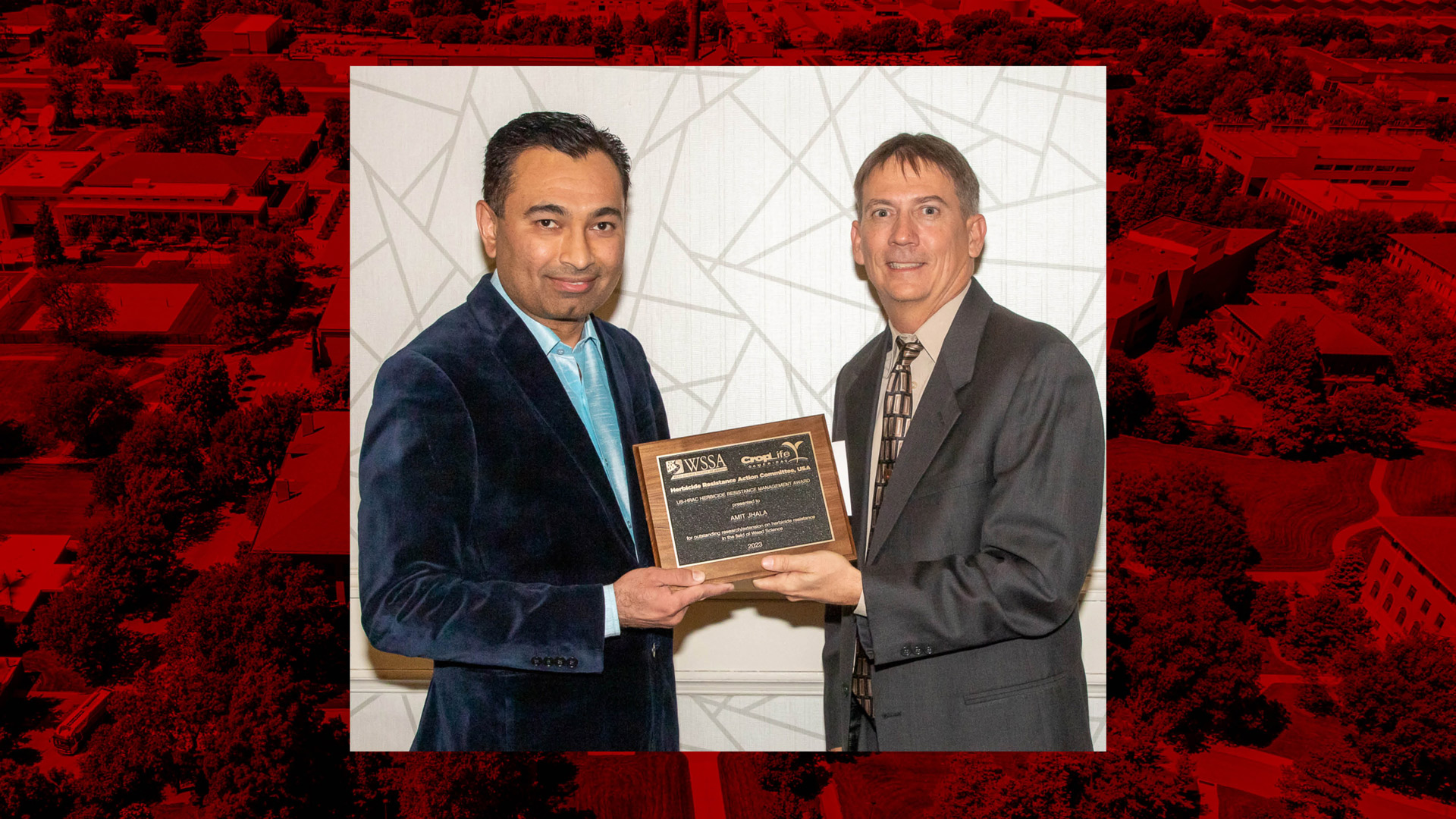 Amit Jhala, left, receives the WSSA Herbicide-Resistant Weed Management Award from Stanley Culpepper, professor and extension weed scientist at the University of Georgia and WSSA past-president.