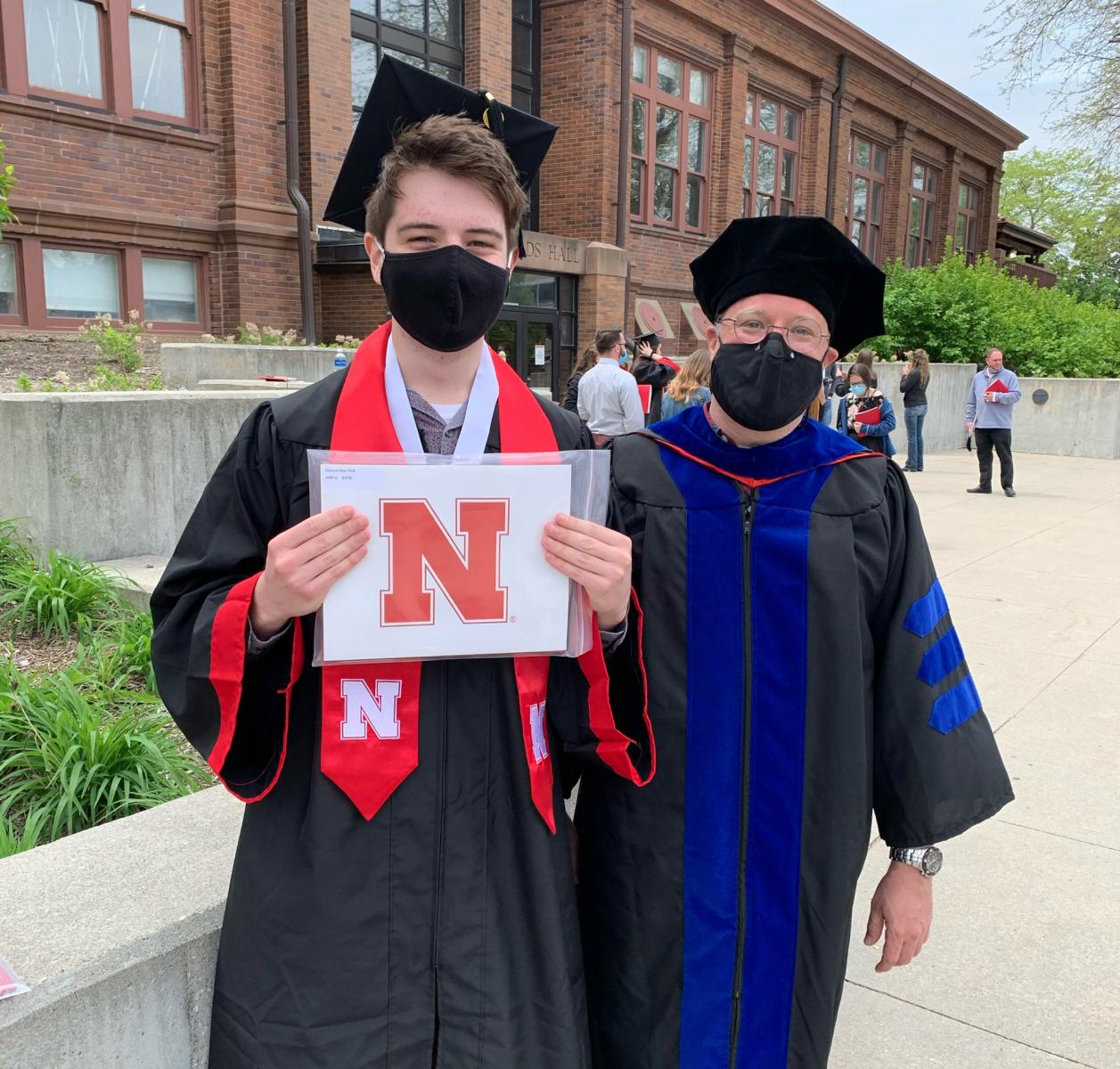 Sam Polk, left, and Christian Elowsky, Department of Agronomy and Horticulture assistant professor of practice, following graduation ceremonies on May 8. 
