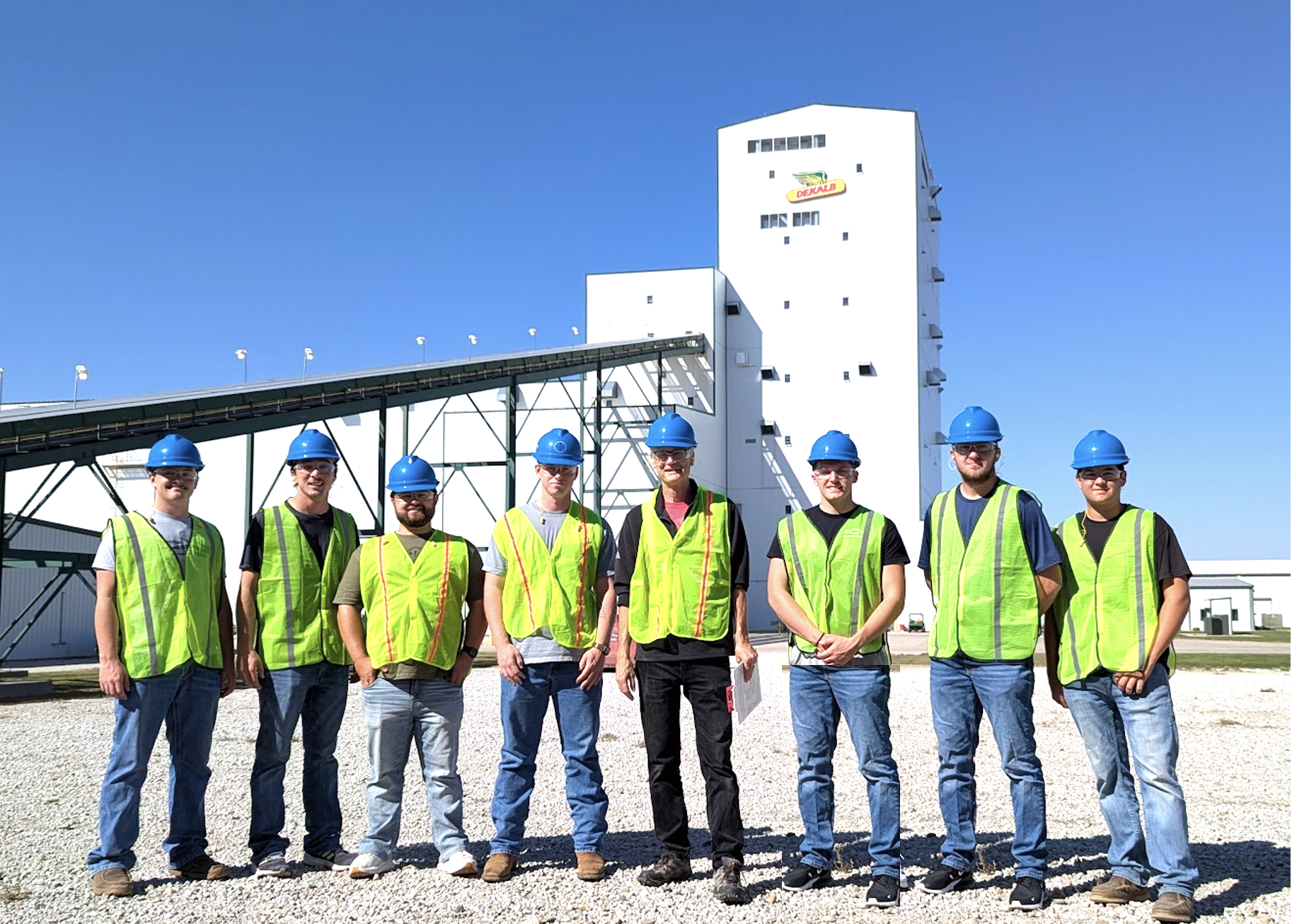 Students tour the Bayer Hybrid Seed Plant near Waco, Nebraska, Sept. 26 and include Nolan Eikerman (from left), Evan Smith, Carson Nagel, Brady Miller, Professor Don Lee, Xavier Ettwein, Payton Gangwish and Carson Ott. Dried ears are sent up this conveyor to the tower. As the seed moves down the tower, the remaining steps of processing are performed. 