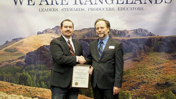 Mitchell Stephenson, left, receives the 2018 SRM Outstanding Young Range Professional Award from SRM 2017 President Larry Howery. Courtesy Photo