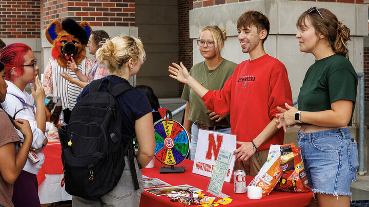 Candid photo of the horticulture club speaking to stuents at the NVolvement Fair on August 27, 2025