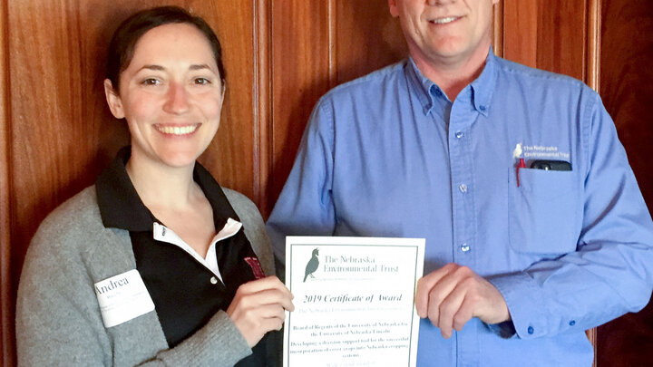 Andrea Basche, left, receives a grant from Mark Brohman, Executive Director of the Nebraska Environmental Trust. Courtesy Nebraska Environmental Trust.