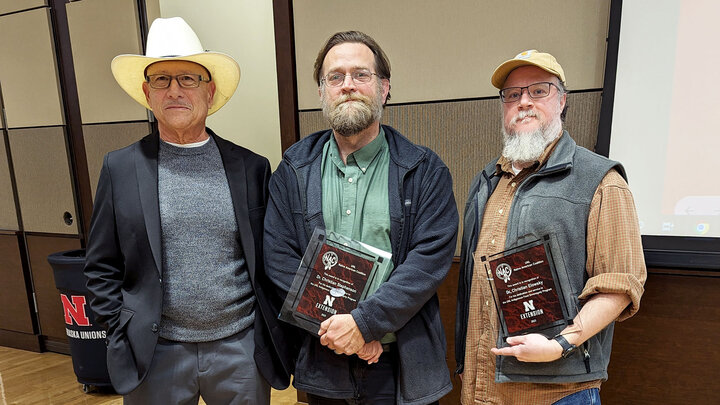 Ted Hibbeler (from left), honors Christian Elowsky and Christian Stephenson for their commitment and time to the University of NebraskaâLincoln Indigenous Youth Food Sovereignty Program.