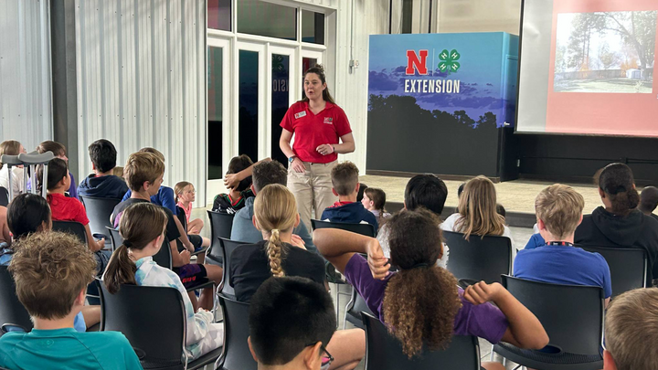 Exstrom teaches Grand Island Publich Schools students about controlled burns at the Golden Sower awards ceremony. The studentss curriculum includes a book about wildfires and controlled burns. 