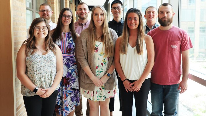Nathan Duffy (back row, left to right), Aaron Seyfert, Yuhao Yan, Joey Geisler, Cecil Renfro (front row, left to right), Megan Franklin, Jennifer Myers, Erin Scholting and Alex Ott celebrate with family, friends, faculty and staff at the department undergraduate graduation reception May 4.