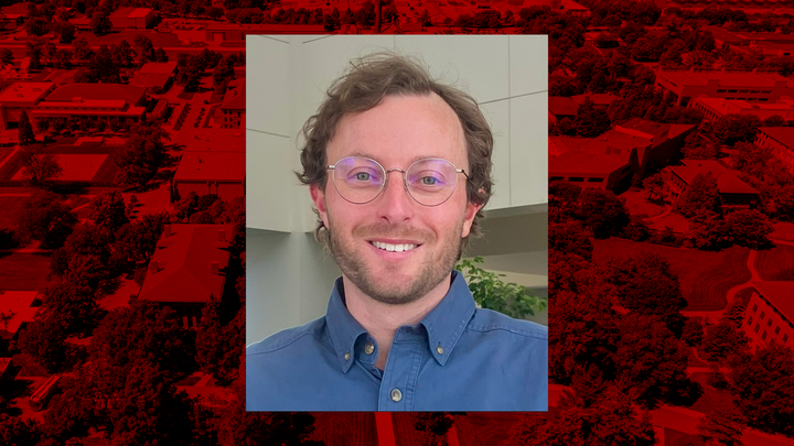 Nathan Butler headshot in front of a red overlain aerial photo of UNL's City Campus