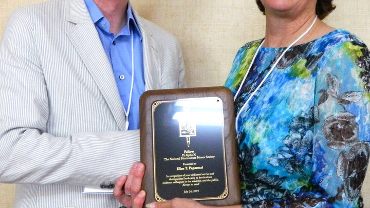 Ellen Paparrozi, right, accepts the Pi Alpha Xi Fellow award from Ryan Contreras, President of Pi Alpha Xi National.