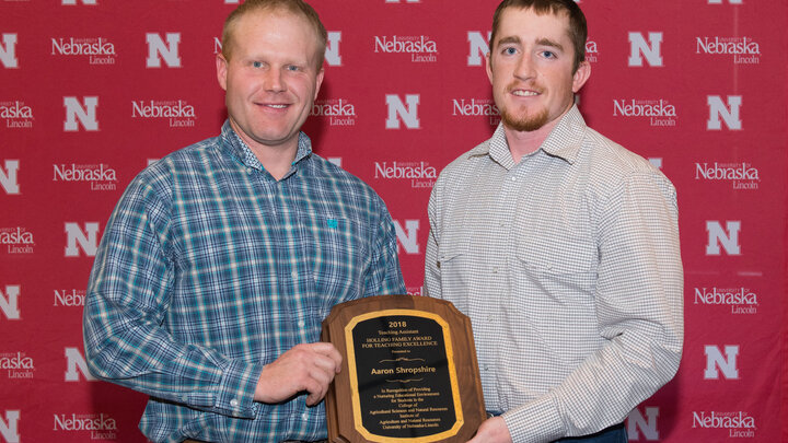 Aaron Shropshire, left, accepts his Teaching Assistant Teaching Excellence Award from Austin Holliday, senior Grazing Livestock Systems major.