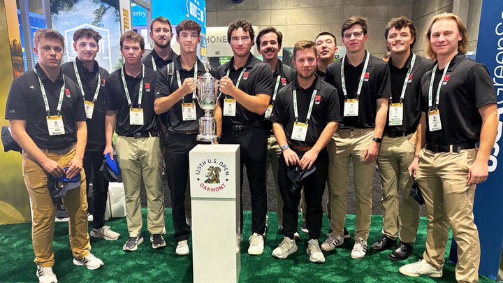 Husker turfgrass competition teams stand with a replica of the U.S. Open trophy on the trade show floor during the GCSAA Conference Feb. 3–6.