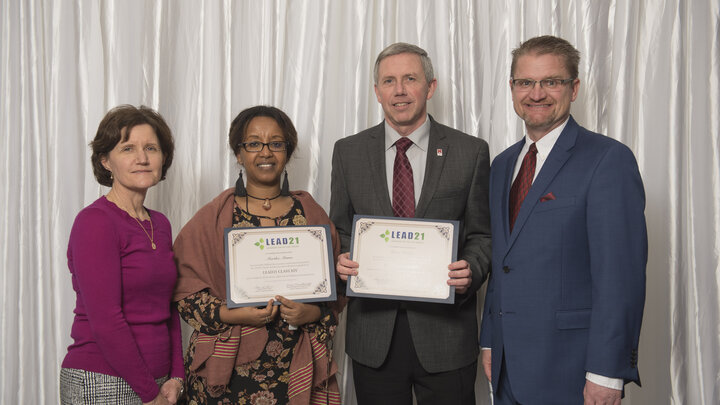 LEAD21 Board Chair Susan Sumner (left) and LEAD21 Program Chair Brian Kowalkowshki (right), award Martha Mamo (middle left) and David Varner (middle right) LEAD21 leadership-development program diplomas Feb. 28. 