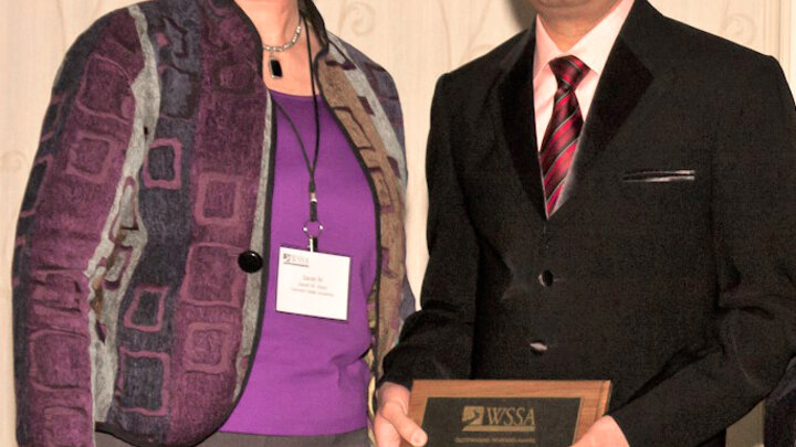 Amit Jhala, right, receives the Outstanding Reviewer Award at the 58th Annual Conference of the Weed Science Society of America. Pictured with Jhala is Sara Ward, director of publication, Weed Science Society of America.