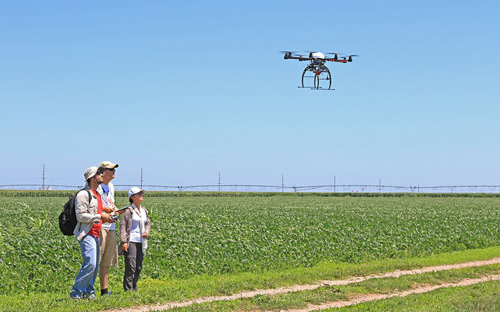 Flying drone in field