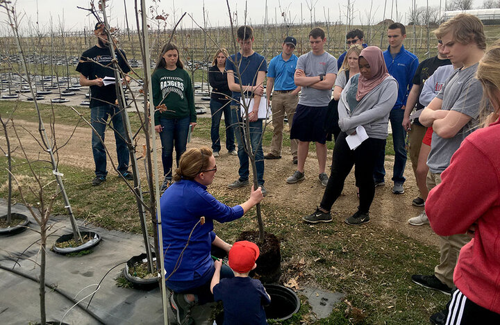 Students in the Horticulture 221 Plant Propagation class listen to University of Nebraska–Lincoln horticulture alumna Heather Byers of Great Plains Nursery discuss nursery management during a spring semester field trip. | Courtesy Sam Wortman, Agronomy and Horticulture
