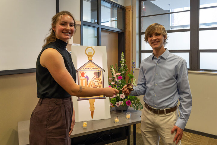 Vice President Elaina Madison hands the gavel to William Anderson