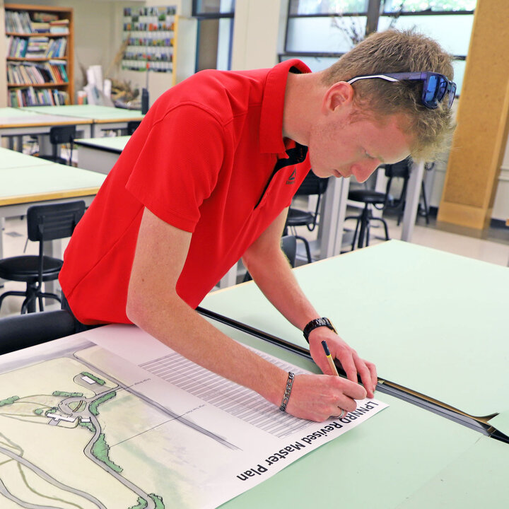 Cory Schumacher, a senior plant and landscape systems major, prepares his final landscape design project in PLAS 469 Ecological Landscape Design to present to the Lower Platte North Natural Resource District. 