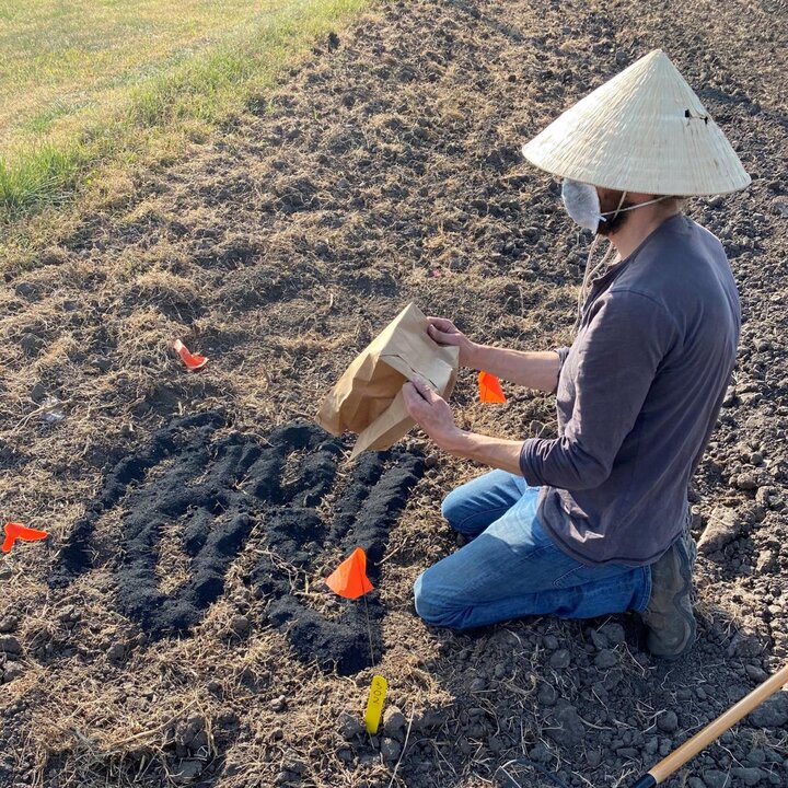 student applying biochar