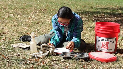 Phuong Minh Tu Le makes notes about her soil texture and soil color determinations during an Oct. 2 practice session in advance of the Region 5 Soil Judging Competition. The competition is being held virtually this year. Lana Koepke Johnson, Department of Agronomy and Horticulture