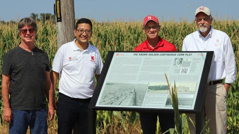 The Historic Knorr-Holden signboard located near the corn plot north of Scottsbluff was officially unveiled on Aug. 23. (From left) Dave Ostdiek, retired UNL PREEC communications specialist; Bijesh Maharjan, UNL associate professor at PREEC and current plot supervisor; Richard Bischoff, UNL IANR associate vice chancellor; and Ron Yoder, UNL IANR senior associate vice-chancellor.