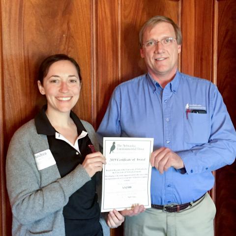 Andrea Basche, left, receives a grant from Mark Brohman, Executive Director of the Nebraska Environmental Trust. Courtesy Nebraska Environmental Trust.