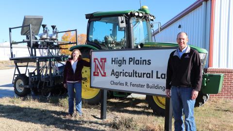 Amanda Easterly and Cody Creech stand by the High Plains Ag Lab office and research building.