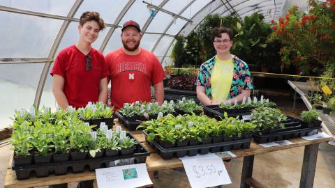 Lydia Regier (from left), Jacob VanDress and Caitlyn Copenhaver sell native plants to the public to raise money for the club in 2023.
