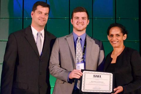 Jeff Lenihan (middle) is awarded a SAFE scholarship, at the Sports Turf Managers Association national conference.