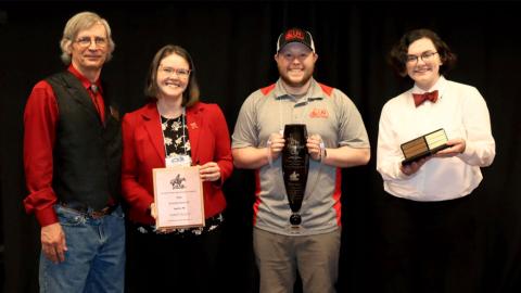 Barry Perryman, past Society for Range Management president, (from left), awards the University of Nebraska–Lincoln team including Josie Ivy, Jacob VanDress and Caitlin Copenhaver, with the first place trophy in the Rangeland Cup during the awards ceremony Jan. 31 at the SRM annual meeting in Sparks, Nevada. 