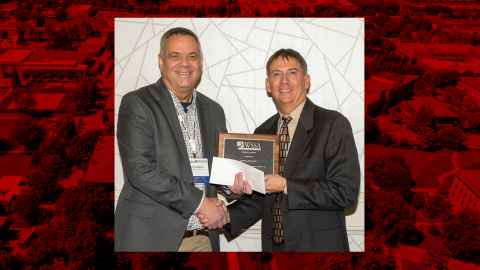 John Lindquist, left, receives the WSSA Outstanding Research Award from Stanley Culpepper, professor and extension weed scientist at the University of Georgia and WSSA past-president.